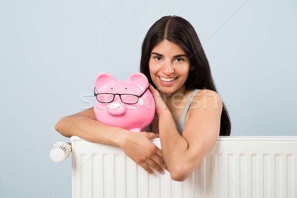 Kobieta skarbonka radiator młoda kobieta różowy Zdjęcia stock © AndreyPopov