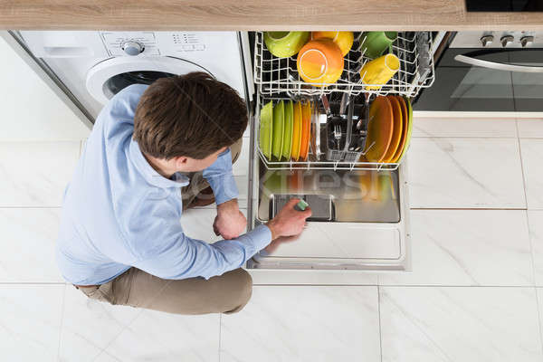 男 食器洗い機 石鹸 タブレット 若い男 洗剤 ストックフォト © AndreyPopov