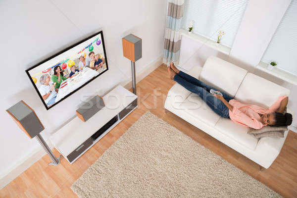 Woman Changing Television Channel Stock photo © AndreyPopov