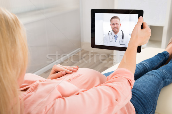 Pregnant Woman Video Conferencing With Doctor On Digital Tablet Stock photo © AndreyPopov