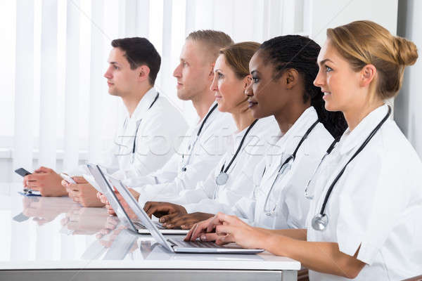 Doctors Using Laptop In Meeting Stock photo © AndreyPopov