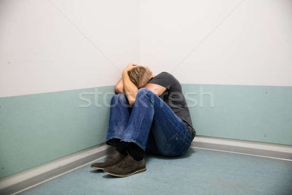Człowiek strach posiedzenia rogu pokój twarz Zdjęcia stock © AndreyPopov