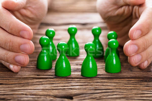 Person Protecting Green Persons Stock photo © AndreyPopov