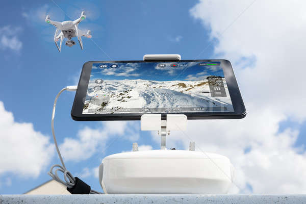 Stock photo: Low angle view of drone filming mountains against cloudy sky