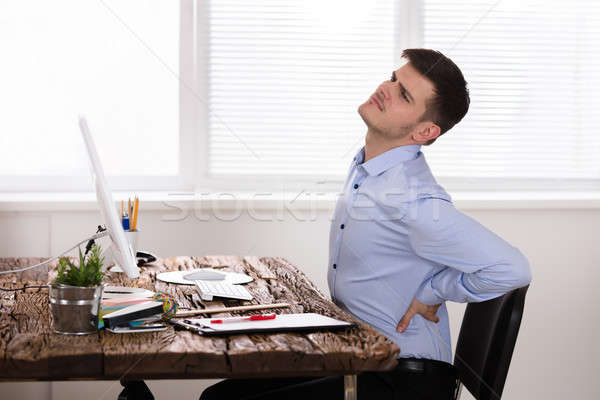 Empresário sofrimento dor nas costas infeliz jovem escritório Foto stock © AndreyPopov