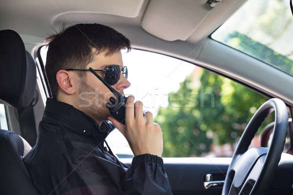 Stock photo: Private Detective Talking On Walkie Talkie