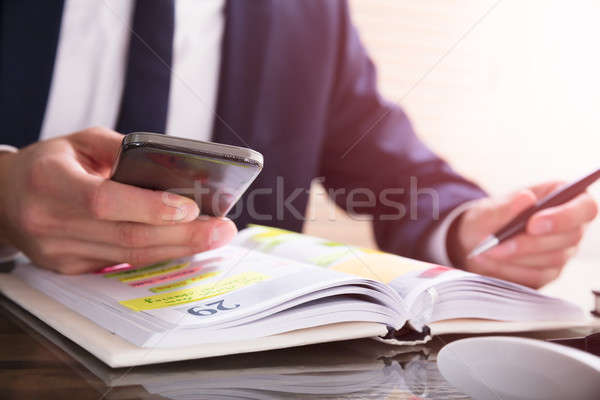 [[stock_photo]]: Homme · d'affaires · téléphone · portable · journal · bureau · main · technologie