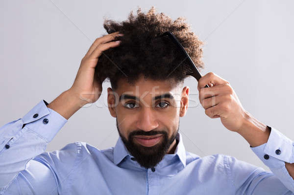 Young Man Combing His Hair Stock photo © AndreyPopov