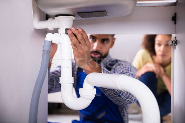 Close-up Of A Plumber Fixing Sink Pipe Stock photo © AndreyPopov