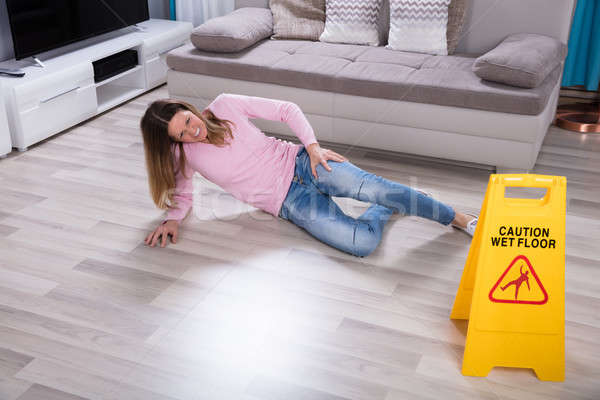 Woman Falling Near Caution Sign At Home Stock photo © AndreyPopov