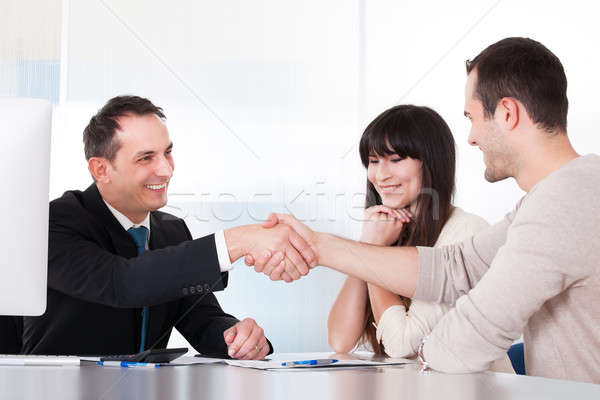 Tanácsadó kézfogás férfi iroda nő pár Stock fotó © AndreyPopov