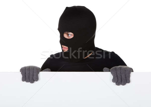 Thief looking around a blank sign Stock photo © AndreyPopov