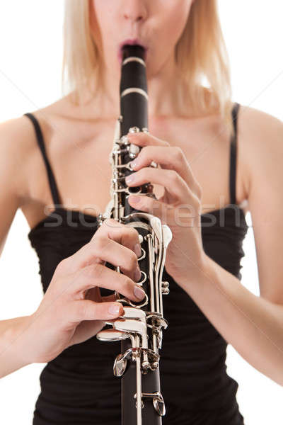 Beautiful young woman playing clarinet Stock photo © AndreyPopov