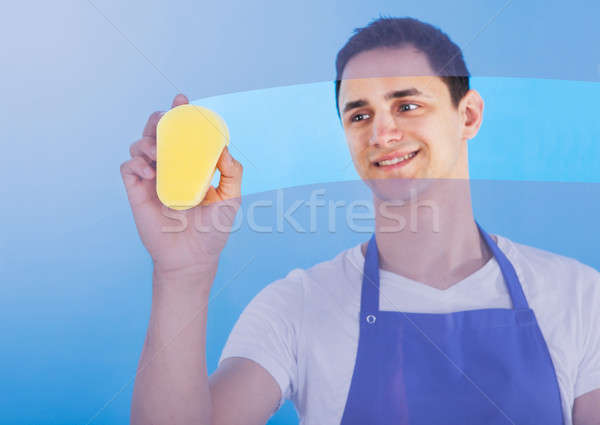 Male Servant Cleaning Glass With Sponge Stock photo © AndreyPopov