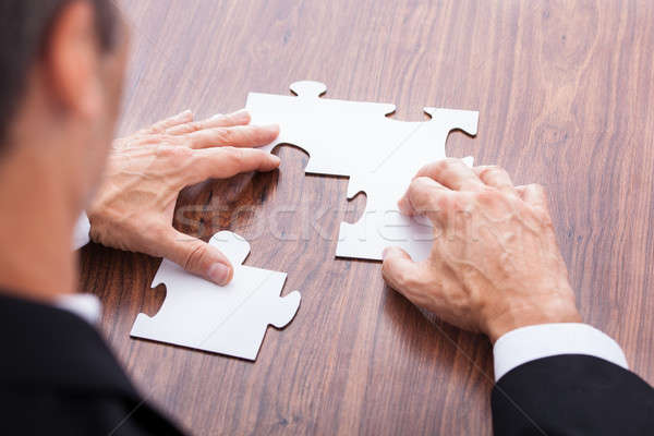 Businessman Solving Jigsaw Puzzle Stock photo © AndreyPopov