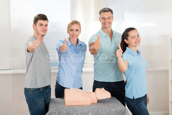 People With Thumbs Up Sign While Learning Resuscitation Stock photo © AndreyPopov