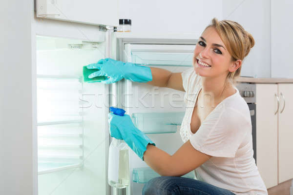 Happy Woman Cleaning Refrigerator At Home Stock photo © AndreyPopov