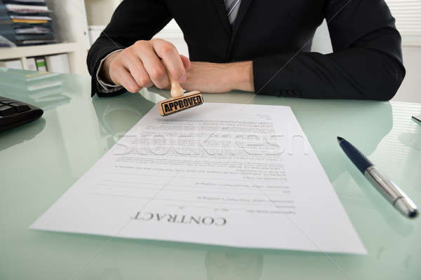 Businessman Stamping On Contract Paper Stock photo © AndreyPopov