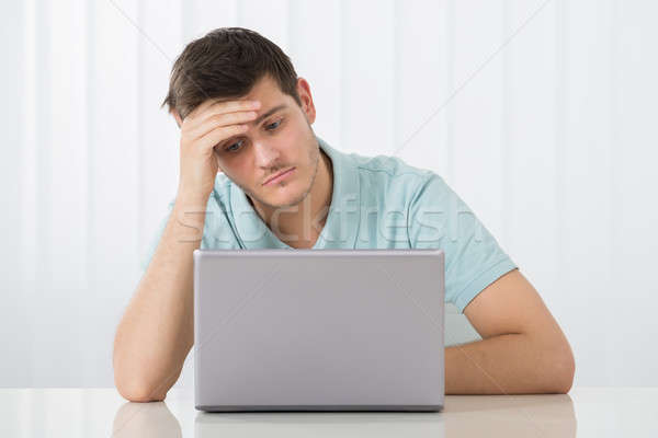 Sad Man Working On Laptop Stock photo © AndreyPopov