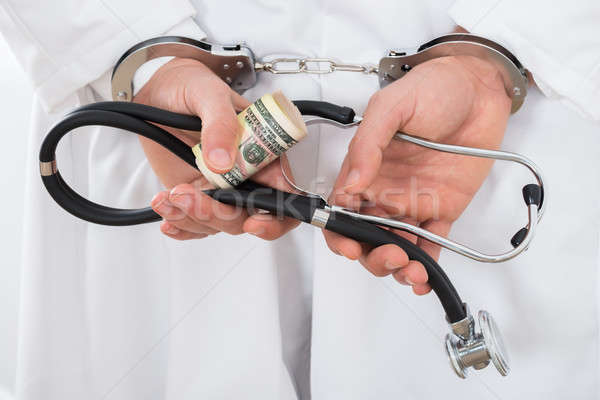 Doctor Hands With Bank Notes And Handcuffs Stock photo © AndreyPopov