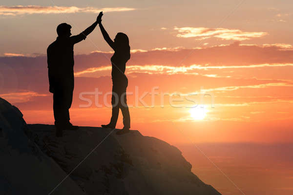 силуэта пару холме молодые женщину солнце Сток-фото © AndreyPopov