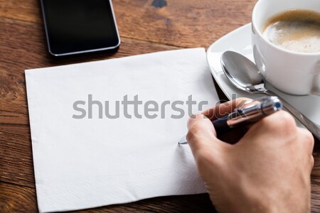 Person Hand Holding Pen On White Paper Stock photo © AndreyPopov