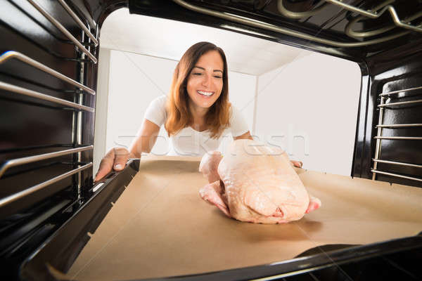 Woman Cooking Chicken In Oven Stock photo © AndreyPopov