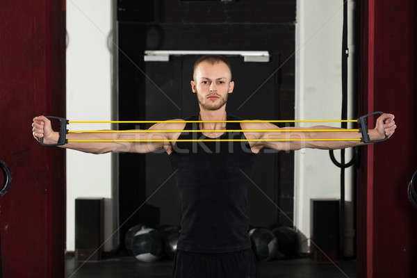 An Athlete Man Working With Stretch Band Stock photo © AndreyPopov