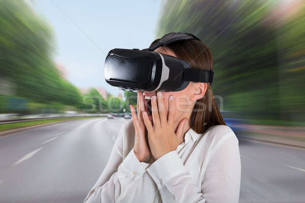 Scared Woman Wearing Virtual Reality Glasses Stock photo © AndreyPopov