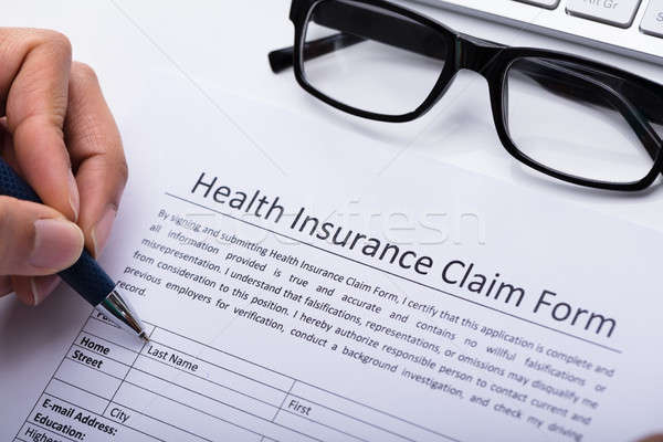Person Filling Health Insurance Claim Form Stock photo © AndreyPopov