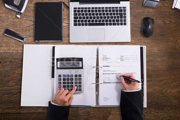 Businessperson Calculating Bill With Calculator Stock photo © AndreyPopov