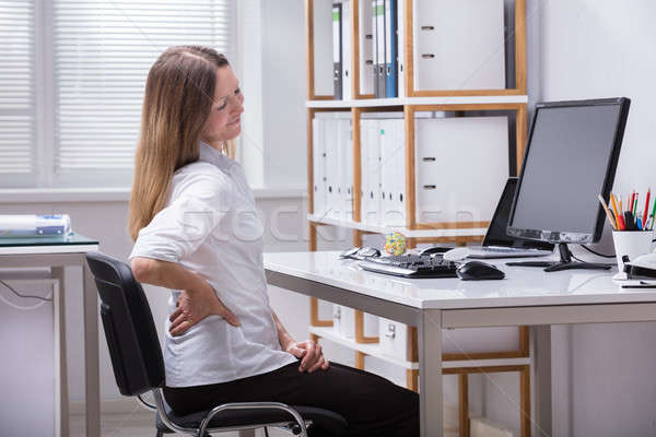Side View Of A Businesswoman Suffering From Back Pain Stock photo © AndreyPopov