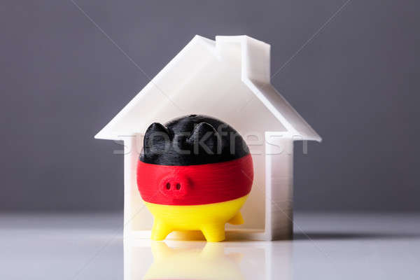Close-up Of Piggybank With German Flag And House Model Stock photo © AndreyPopov