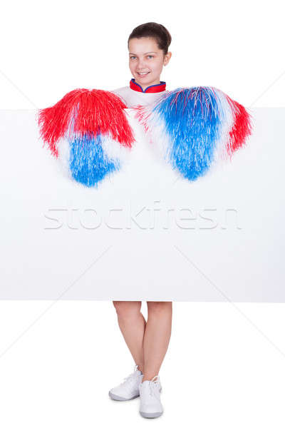 Young cheerleader holding a blank sign Stock photo © AndreyPopov