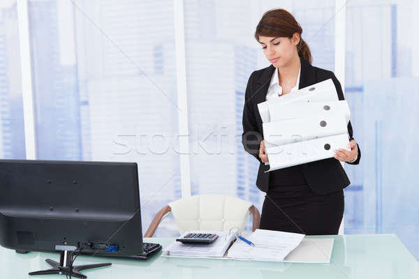 Businesswoman Carrying Binders In Office Stock photo © AndreyPopov