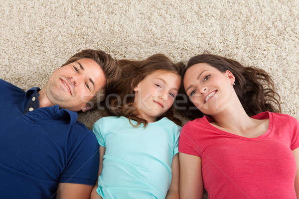 Portrait Of Family Lying On Rug Stock photo © AndreyPopov