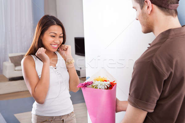Stock photo: Woman Receiving Bouquet From Delivery Man