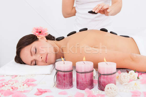 Person Placing Lastone On Woman's Back Stock photo © AndreyPopov