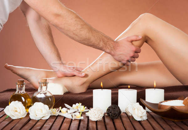 Therapist Massaging Customer's Leg At Beauty Spa Stock photo © AndreyPopov