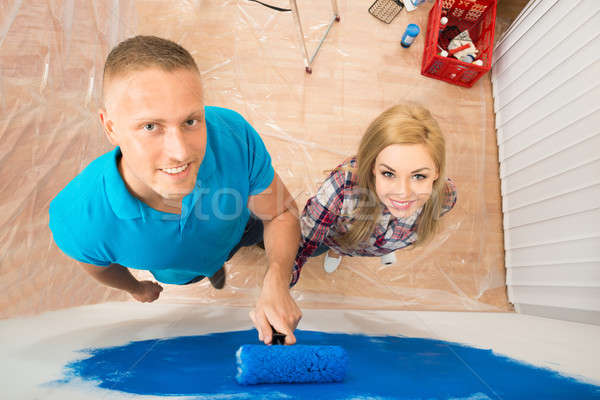 Young Couple Painting In New Home Stock photo © AndreyPopov