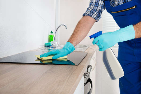 Stock photo: Worker Cleaning Electric Hob