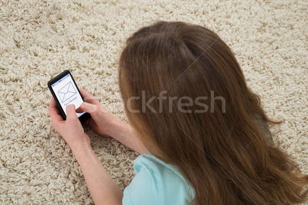 Girl Checking Message On Mobile Phone Stock photo © AndreyPopov