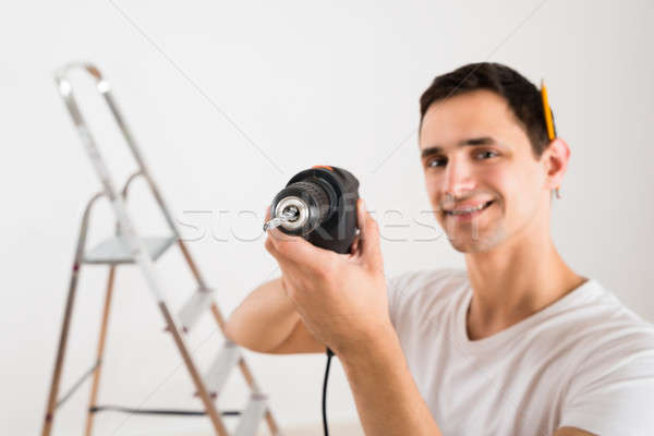 Portrait Of Smiling Man Holding Power Drill Stock photo © AndreyPopov