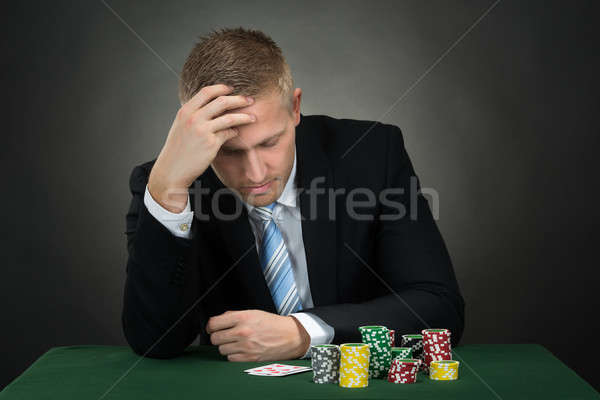 Portré lehangolt fiatal férfi póker játékos Stock fotó © AndreyPopov