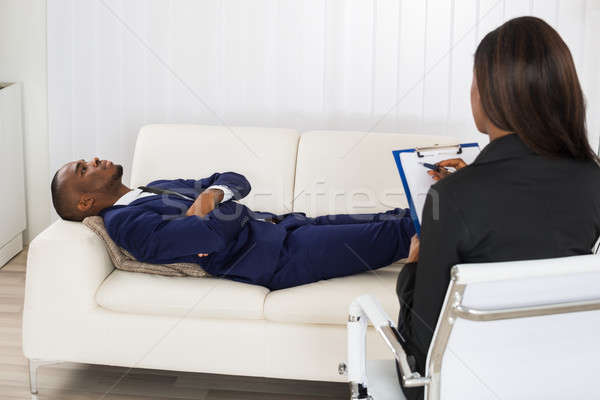 Paziente divano psichiatra african american uomo Foto d'archivio © AndreyPopov