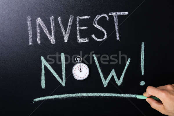 Invest Now Concept Written On Blackboard Stock photo © AndreyPopov