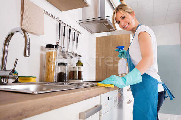 Smiling Woman Cleaning Kitchen Worktop Stock photo © AndreyPopov