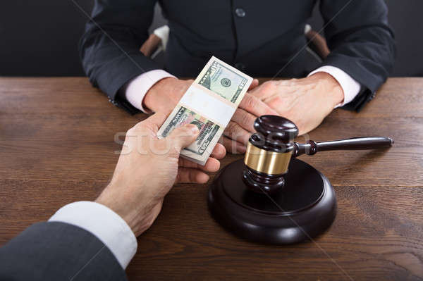 Businessman Giving A Bribe To A Judge Stock photo © AndreyPopov