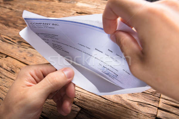 Businessman Opening Envelope With Paycheck Stock photo © AndreyPopov