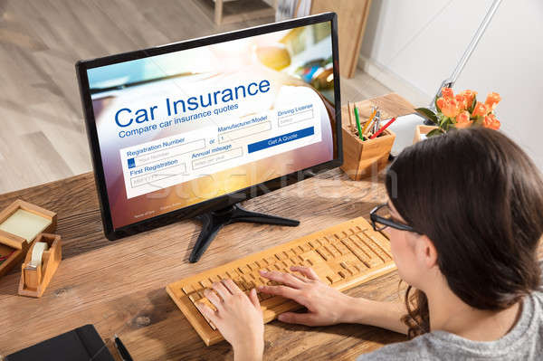 Woman Filling The Car Insurance Form On Computer Stock photo © AndreyPopov